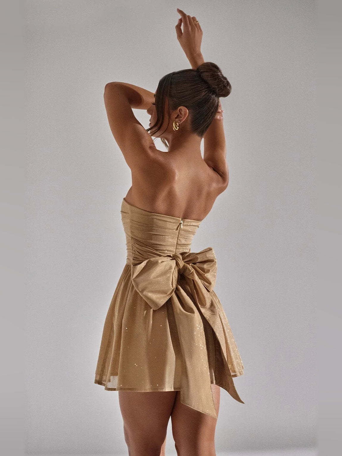Mocha gold back view mini dress with tied waist bow and flared tulle skirt