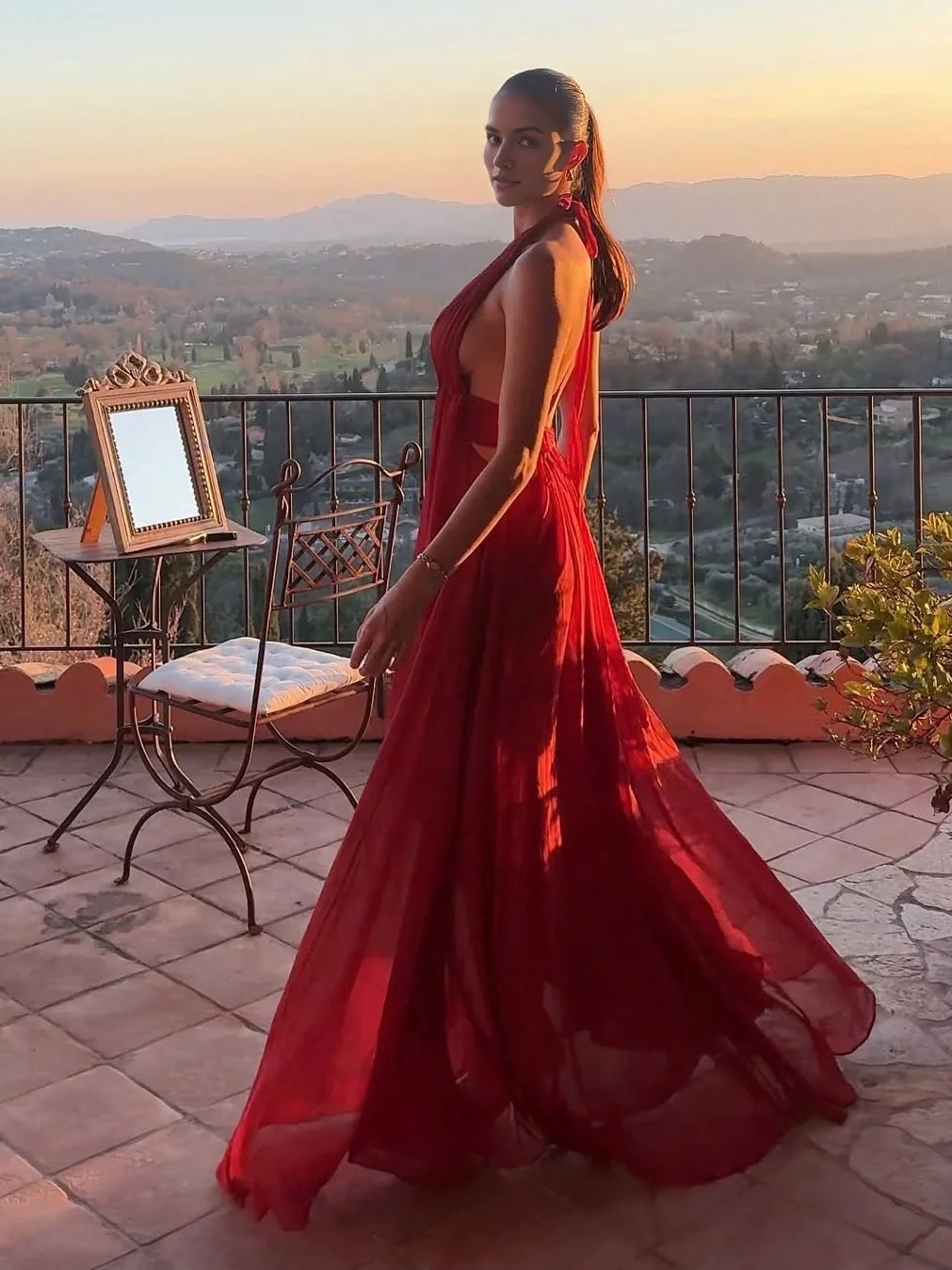 Red sleeveless V-neck floor-length formal dress with gathered waist and skirt