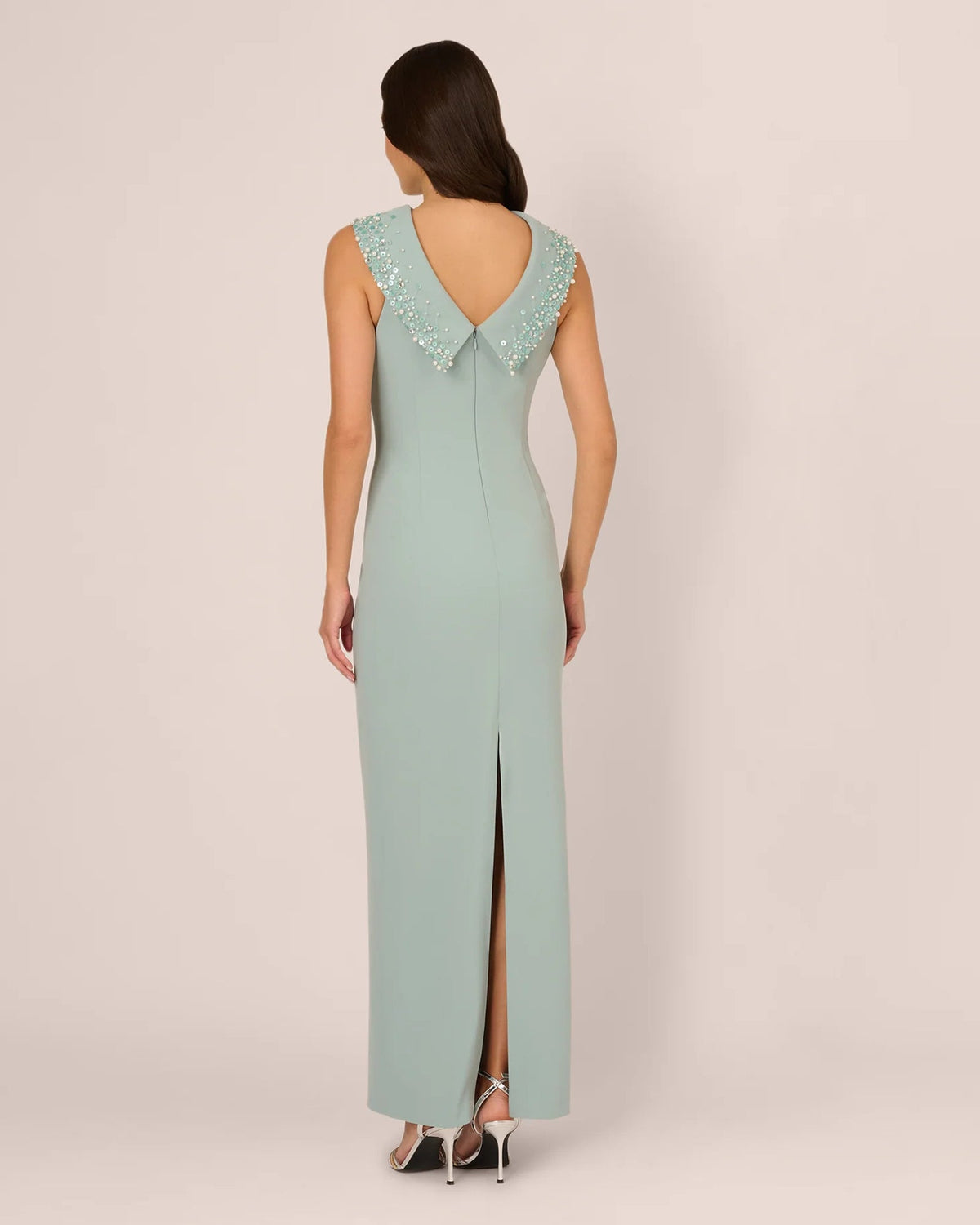 Pale aqua sheath maxi dress shown from behind with embellished off-shoulder shoulder detail.