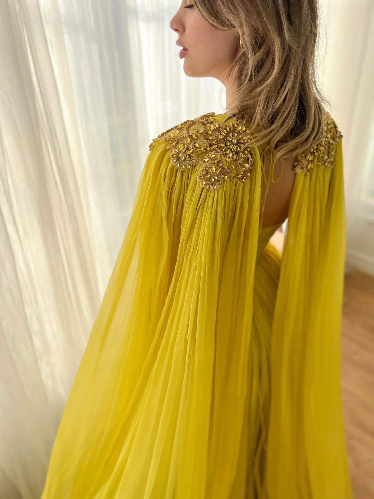 Yellow floor-length formal dress with jeweled shoulders and open back