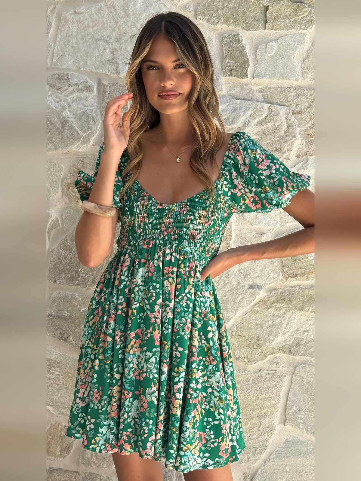 Green floral mini dress with puff sleeves, scoop neckline, and gathered skirt