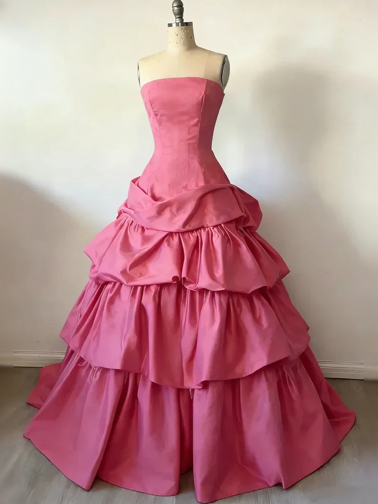 Pink satin strapless corset ball gown with tiered ruffle skirt on mannequin