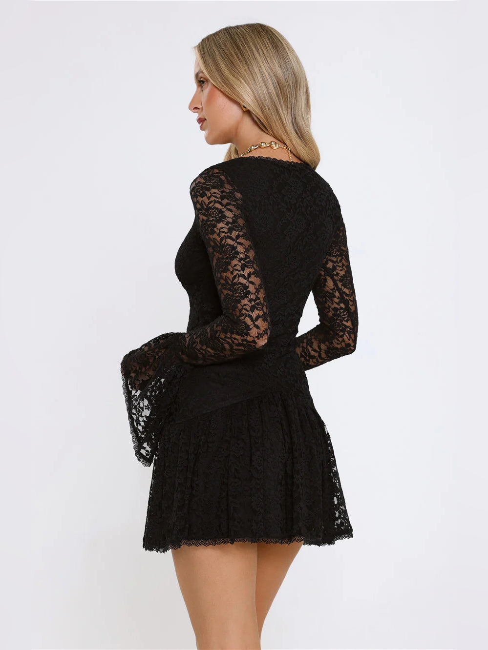 Black long-sleeve lace mini dress with V-neck front and tiered ruffle skirt