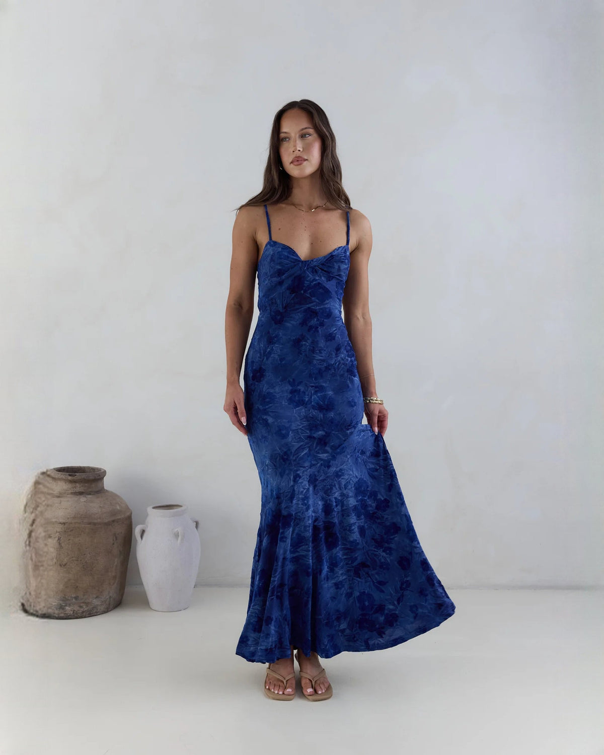 Navy sleeveless mesh maxi dress with thin straps, sweetheart neckline, and flared A-line hem.