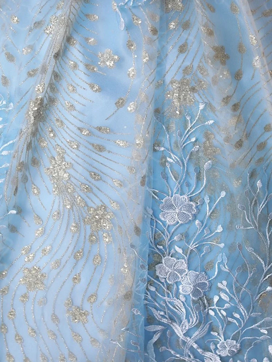 Sky blue tulle bodice close-up with ornate floral embroidery and sparkling beadwork