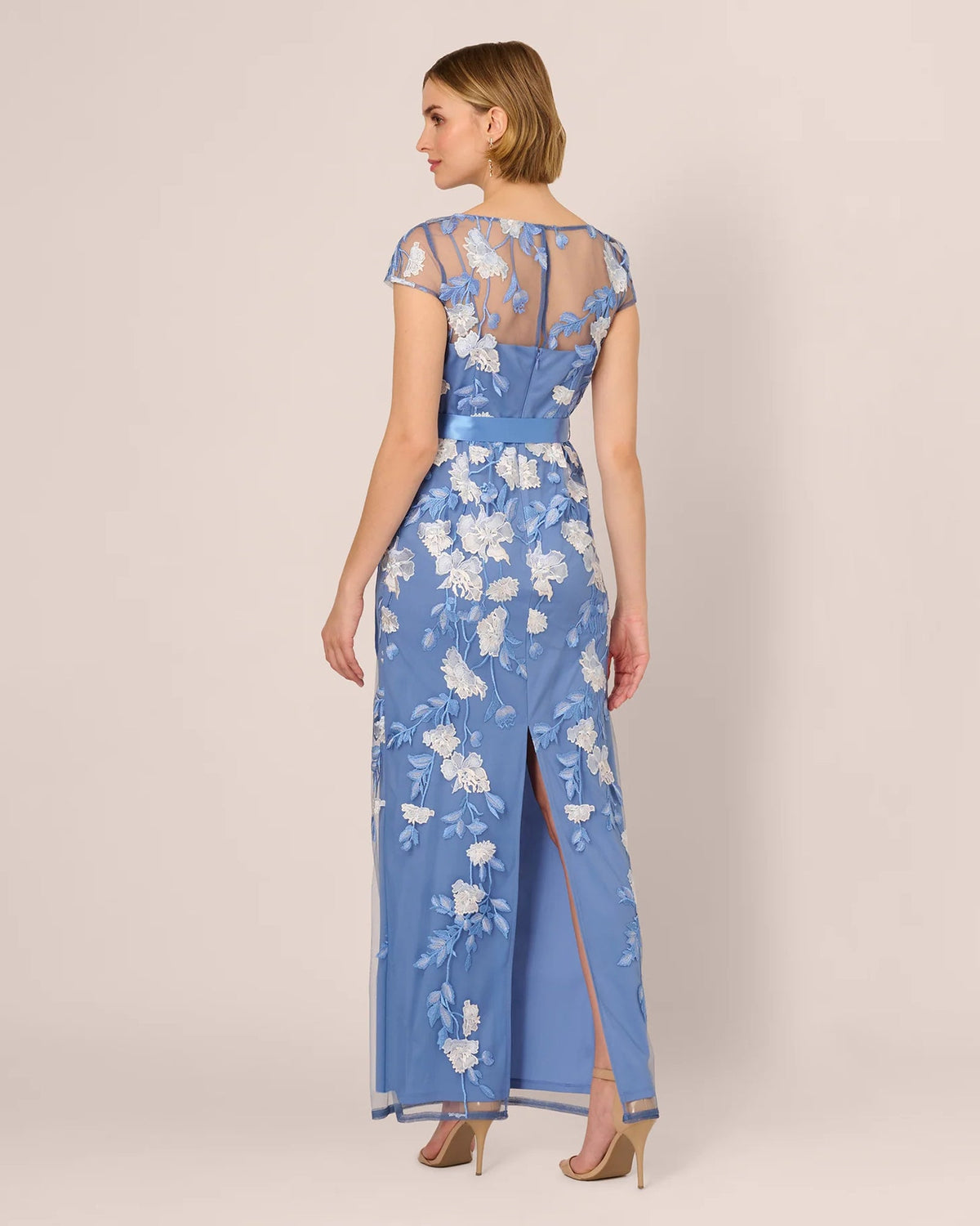 Blue floral short-sleeve A-line maxi dress with ribbon belt at waist, side view