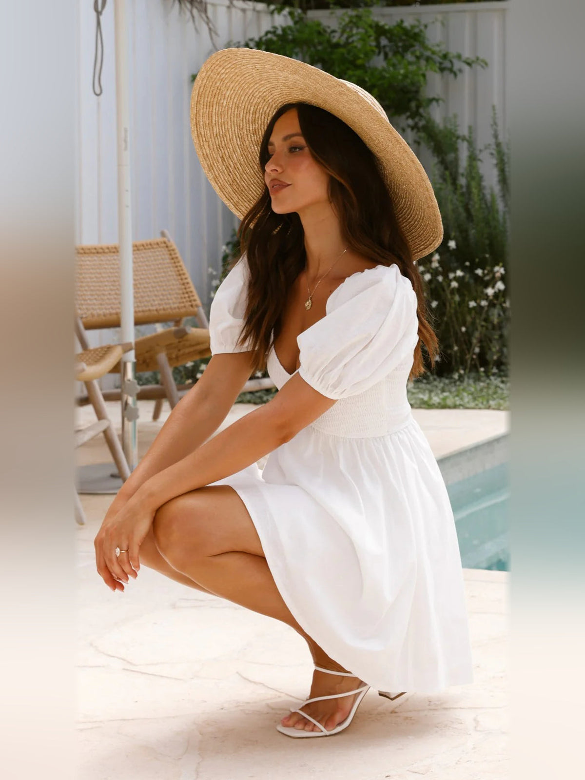 White mini homecoming dress with V-neck, puff sleeves, and short flared skirt