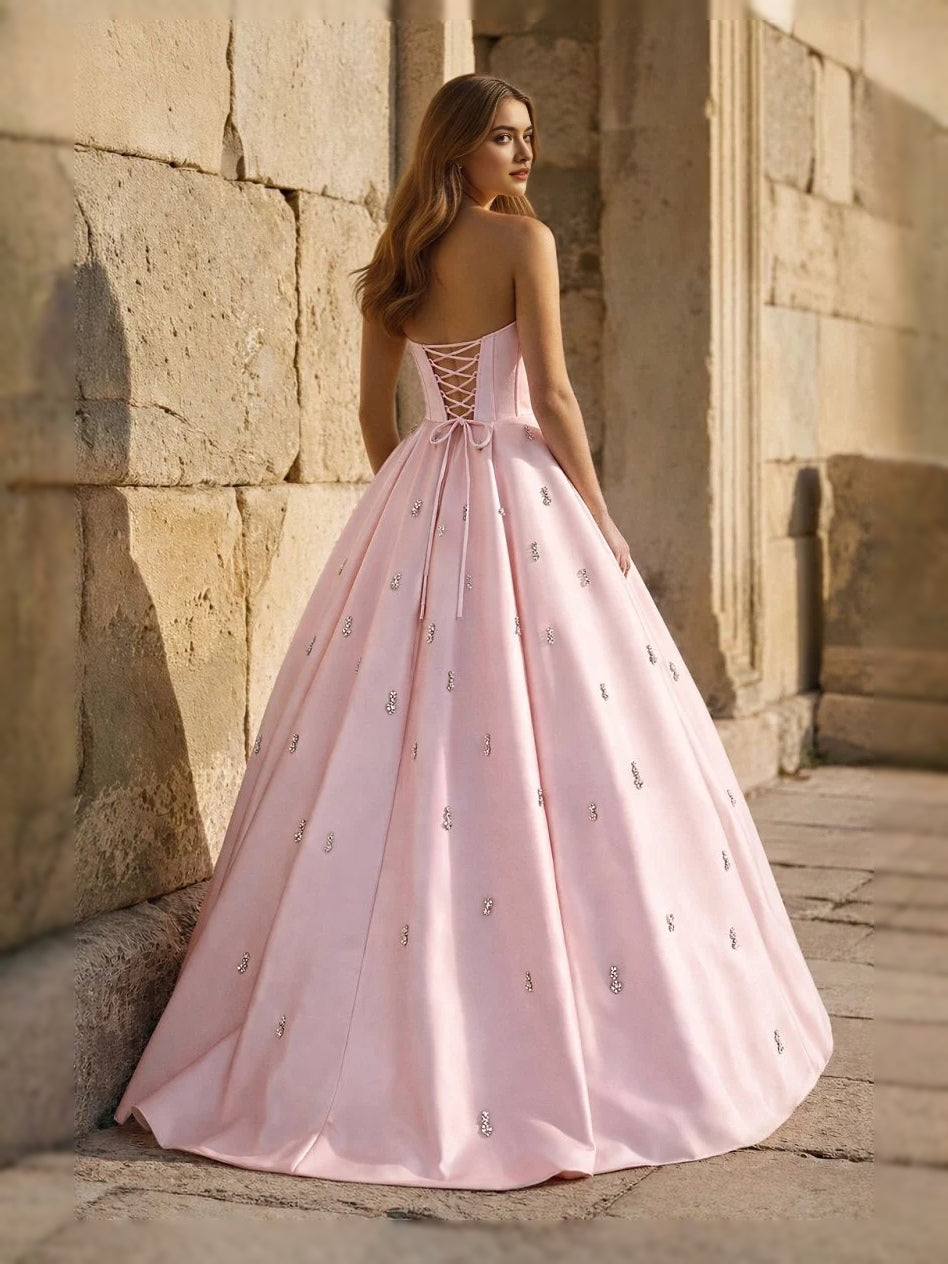 Blush pink sweetheart corset ball gown with thin straps and full floor-length skirt, front view