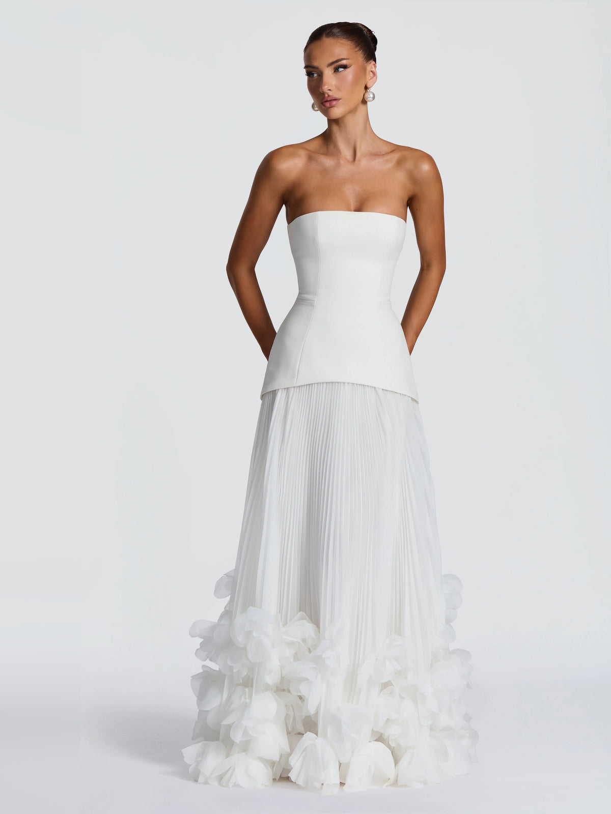 Ivory strapless wedding dress with structured corset bodice and tiered floral ruffle skirt