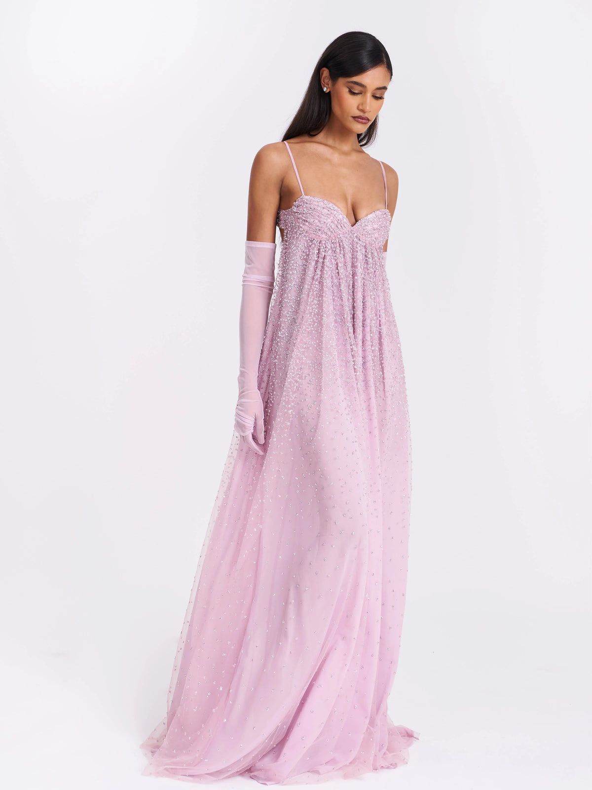 Dusty rose A-line tulle prom dress with sparkling beading, spaghetti straps, and sheer sleeves