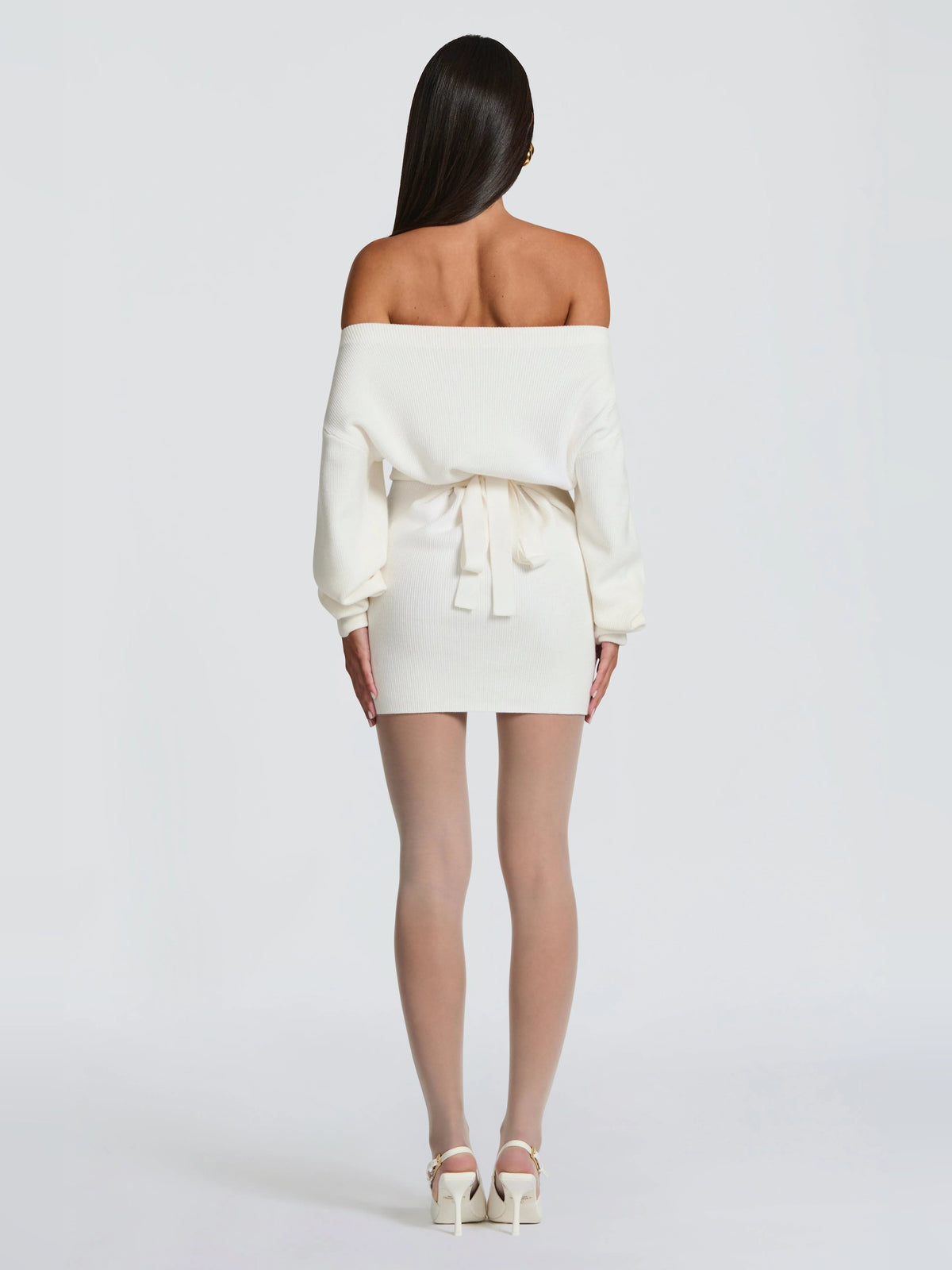 Back view of ivory off-shoulder mini dress with ruched waist and tied detail