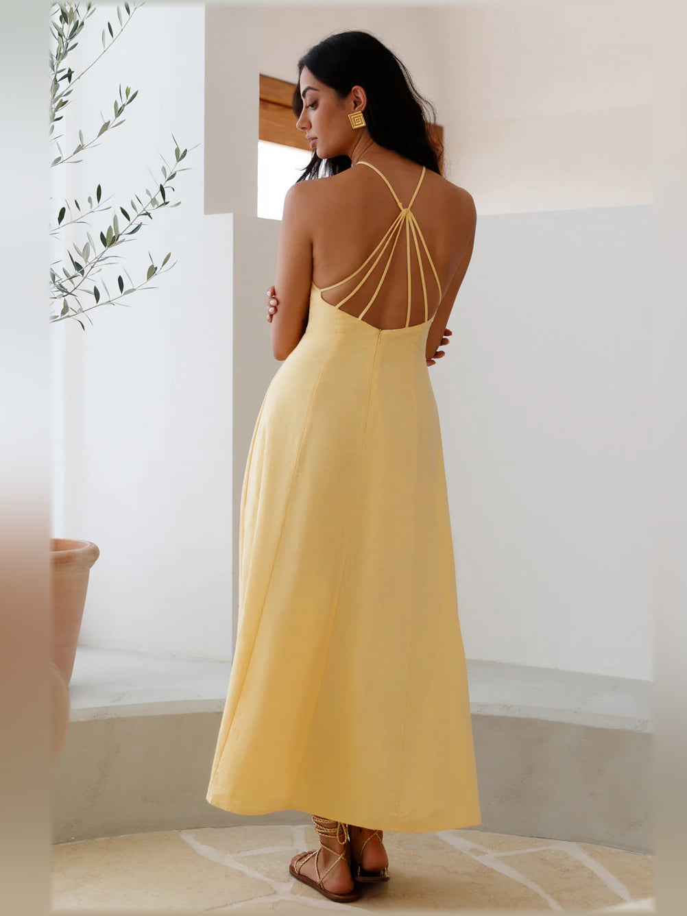 Yellow midi formal dress with open back crisscross straps and halter neckline