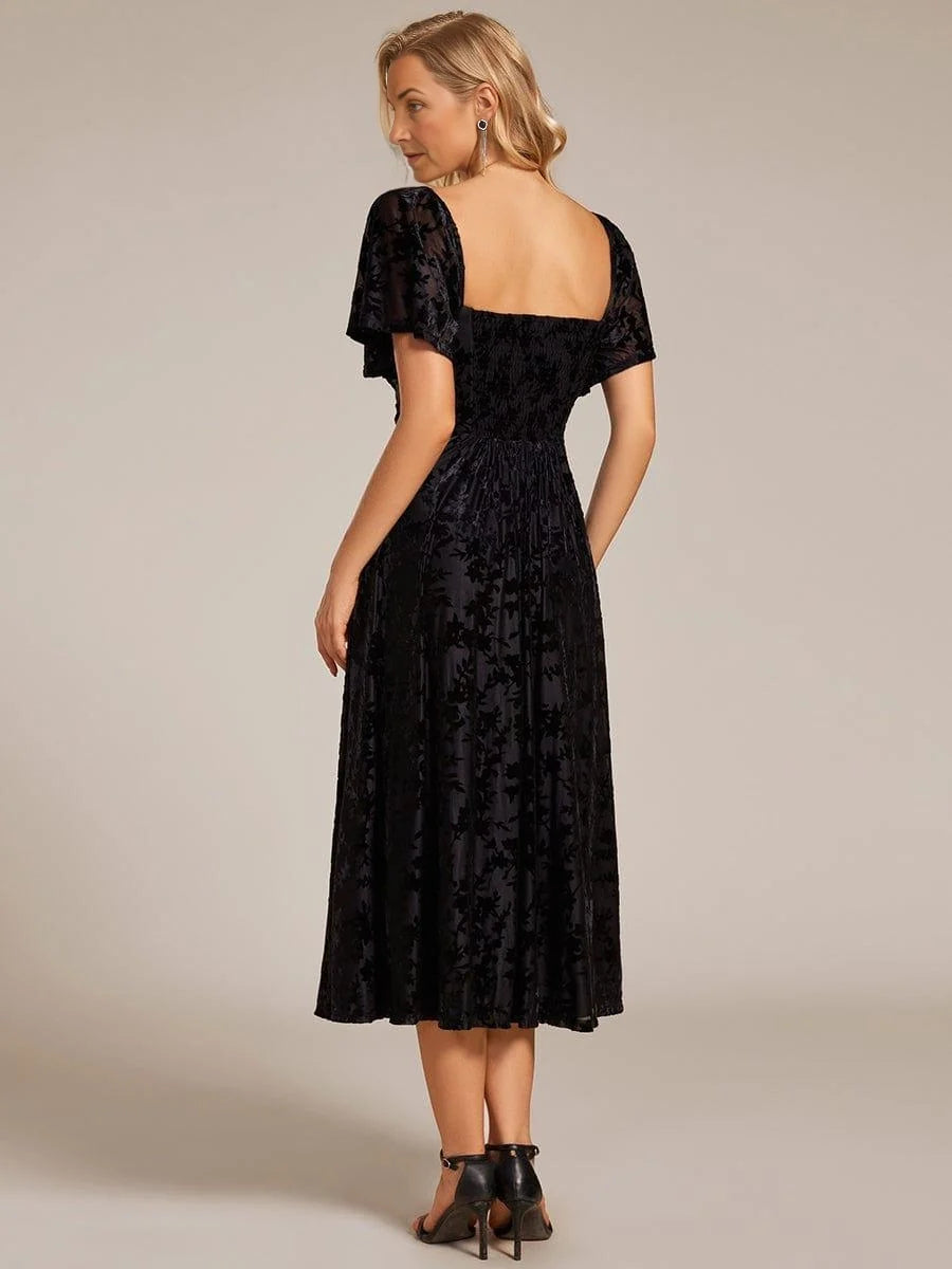 Black A-line midi dress with square back and short puff sleeves