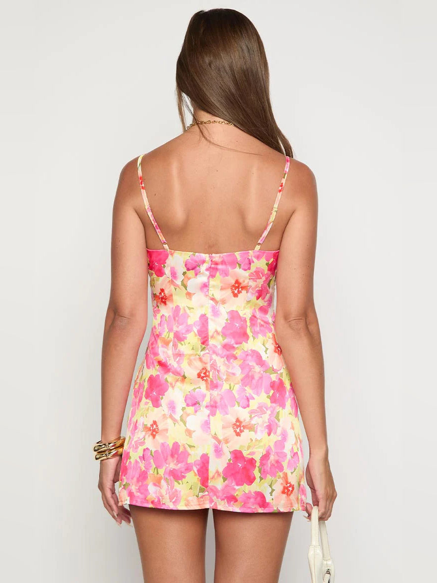 Back view of floral mini dress with thin straps, open back, pink and yellow print