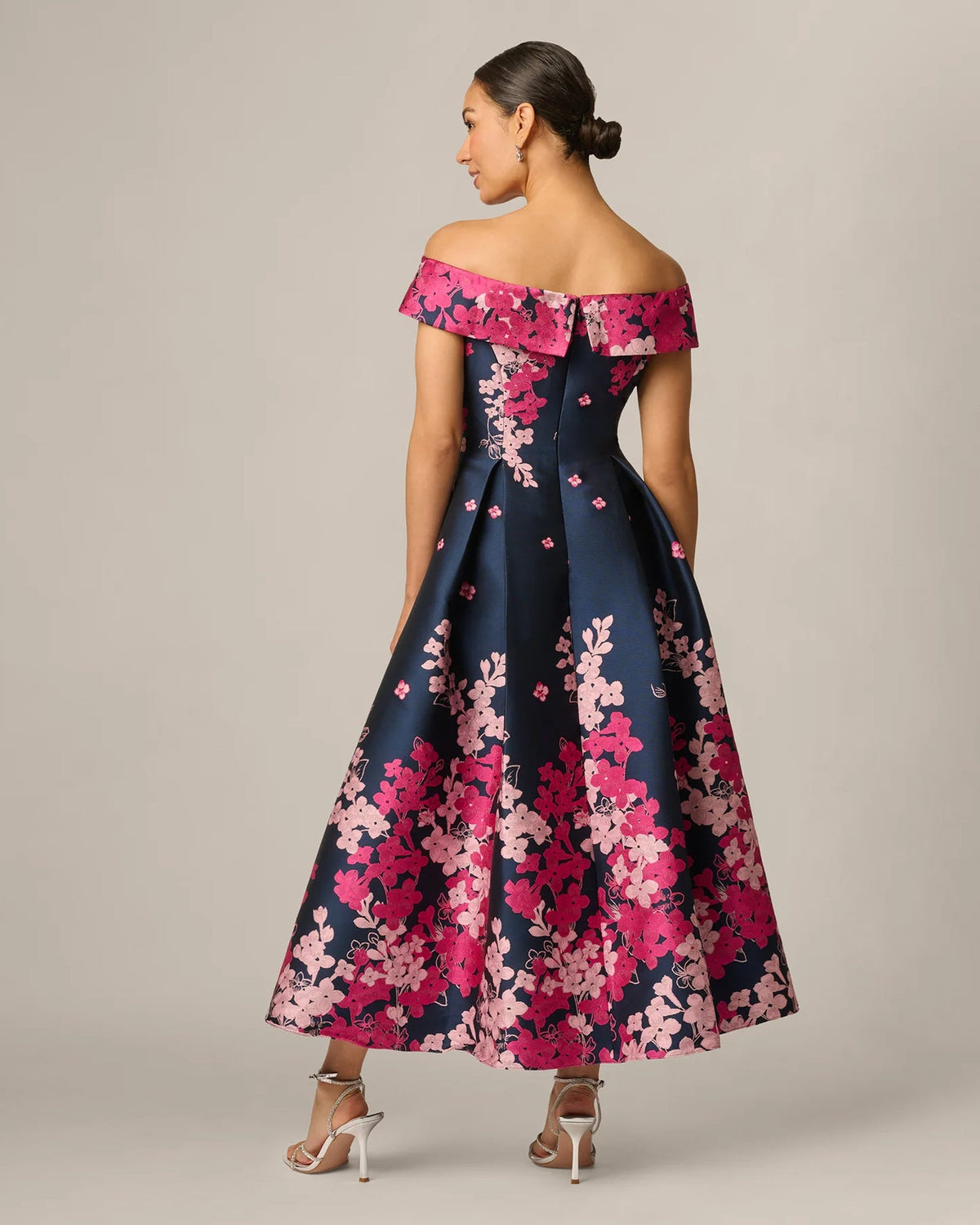 Back view of navy A-line maxi dress with pink floral off-shoulder neckline
