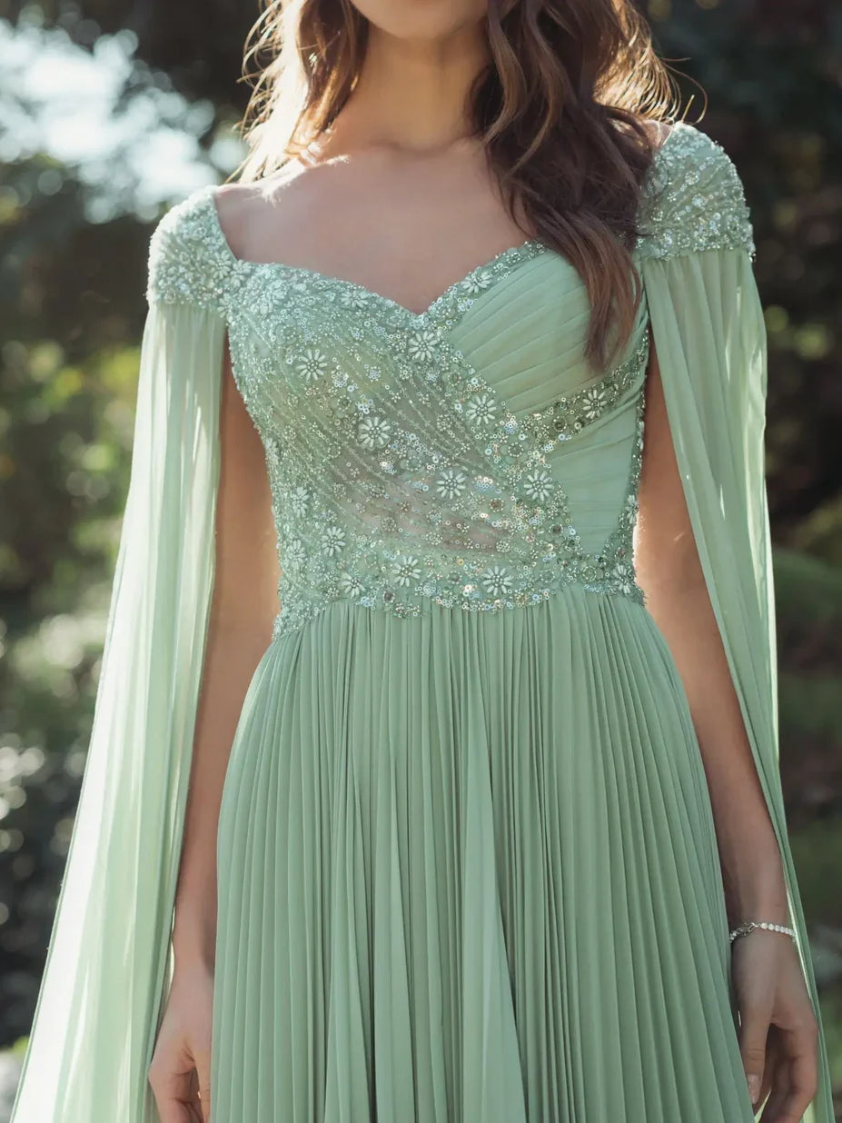 Dusty sage beaded sweetheart dress with pleated skirt and sheer cape sleeves