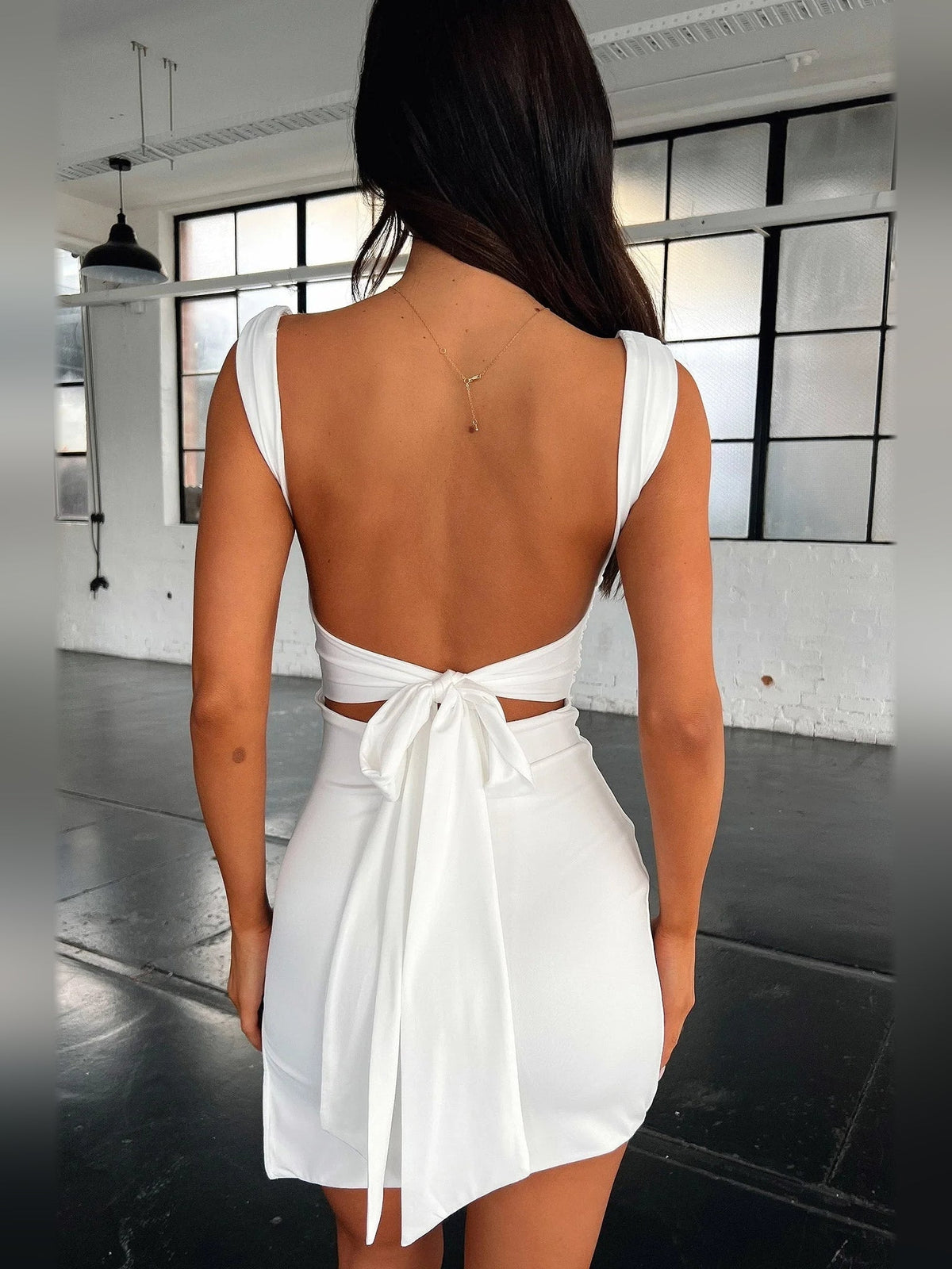 Ivory white ruched backless mini dress with square straps and large tied back bow
