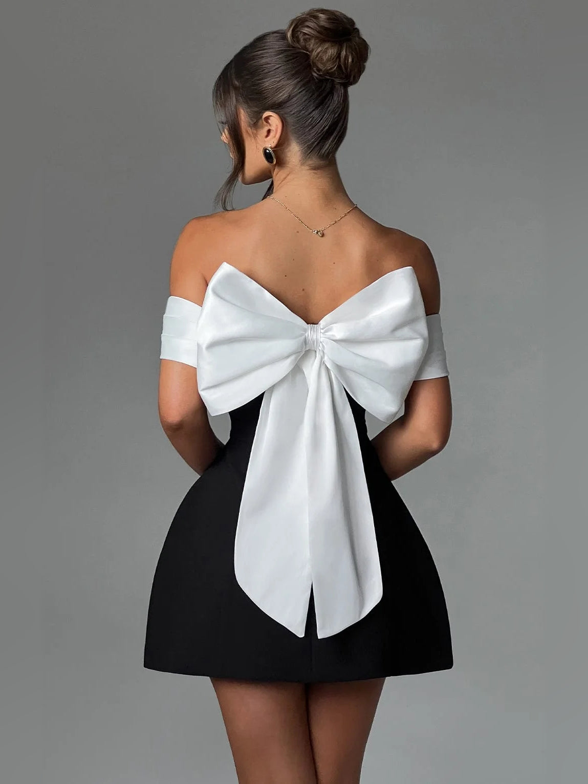 White off-shoulder A-line mini satin dress with large back bow