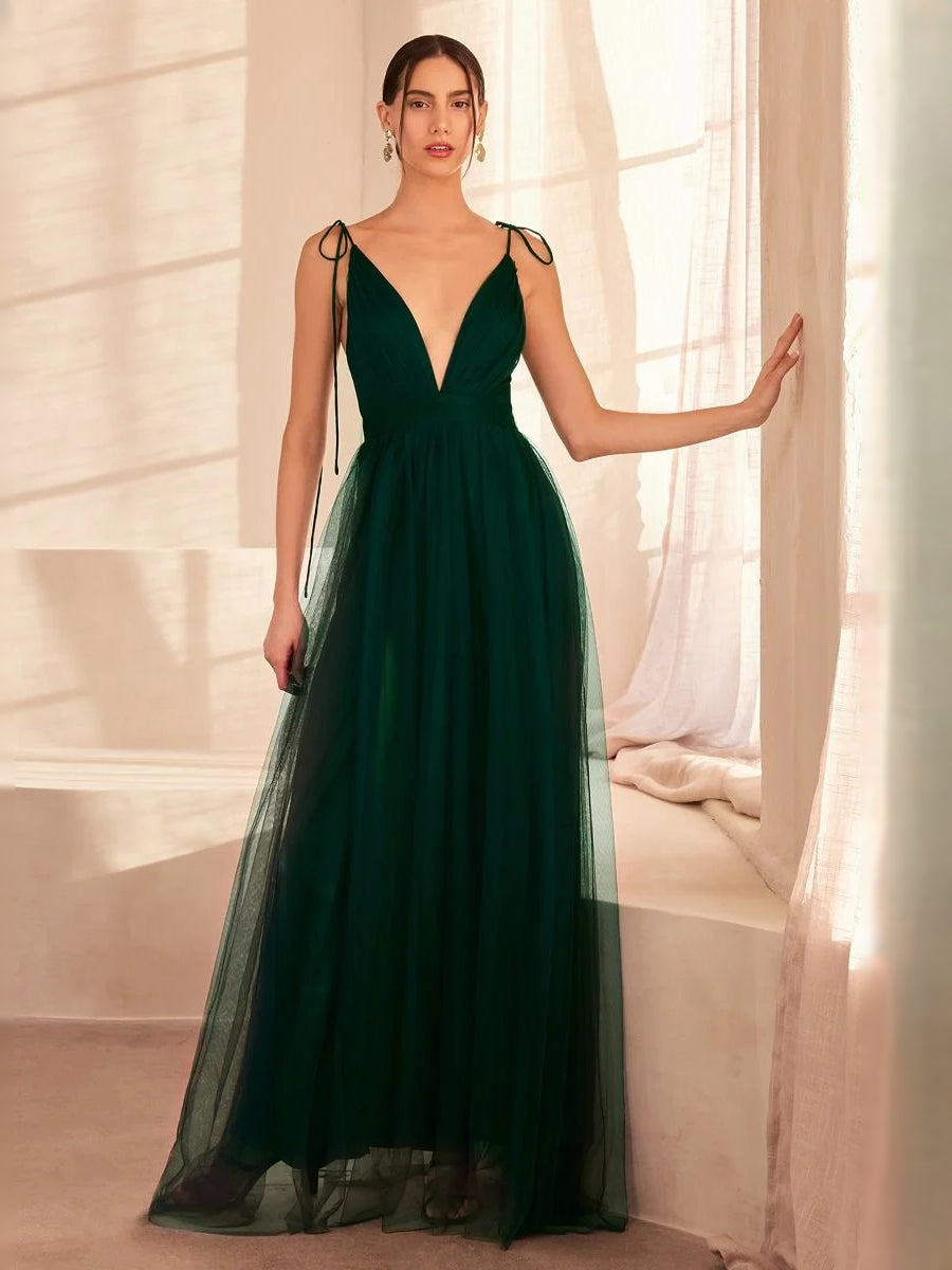 Emerald green V-neck A-line maxi tulle prom dress with tied straps and flowing skirt