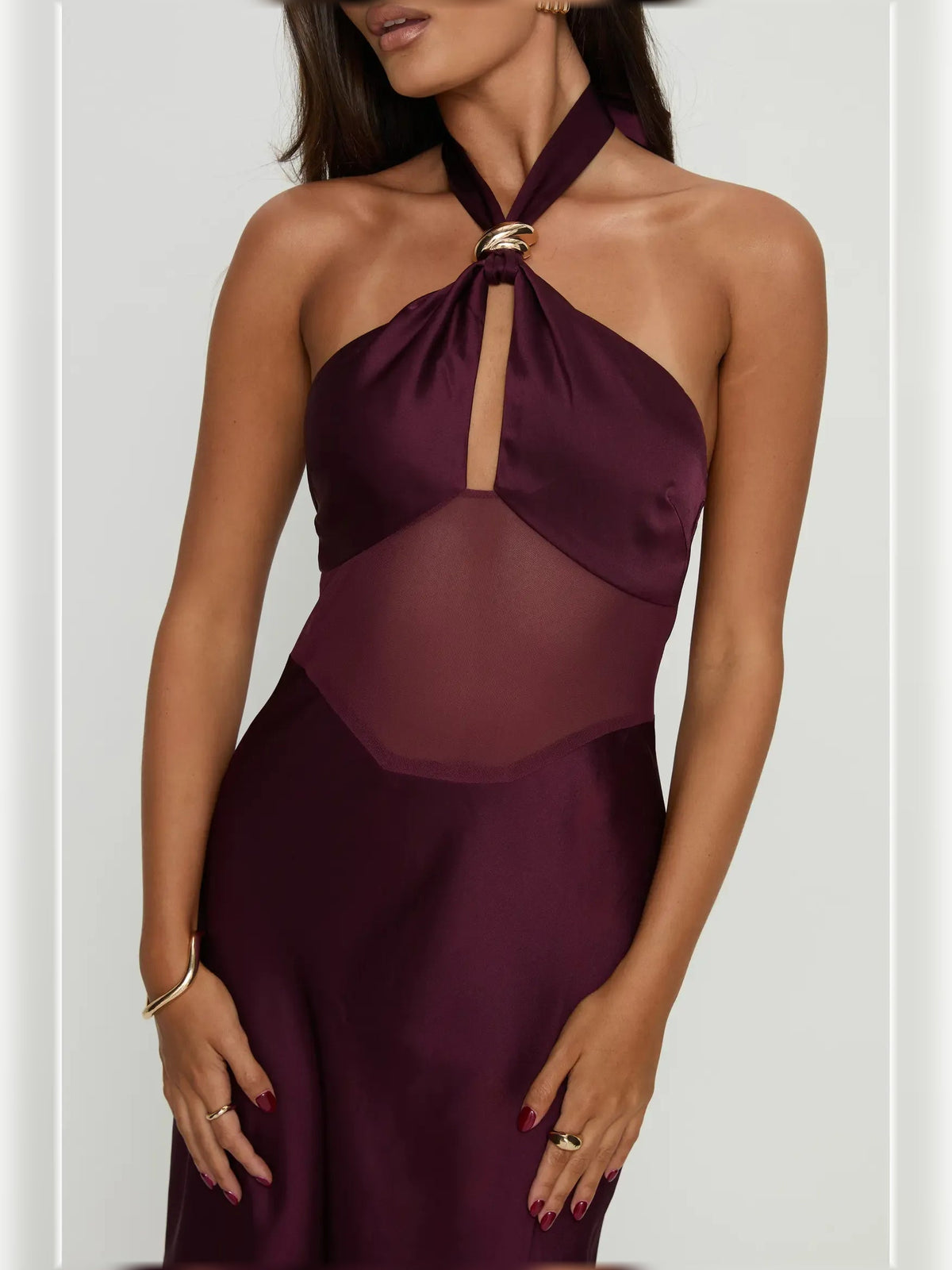 Plum halter neck dress with keyhole neck tie, draped sheer panel, and layered skirt