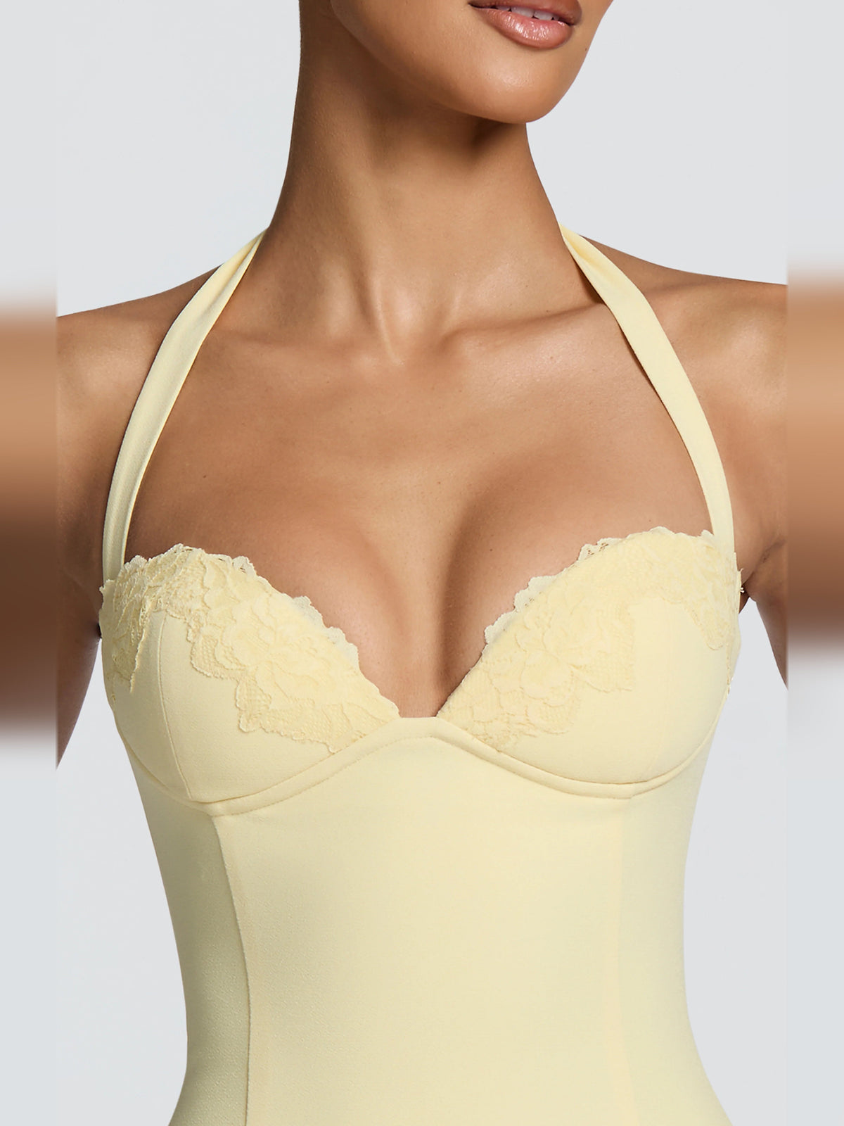 Lemon halter mini dress with lace-trim plunge cups and smooth fitted bodice.