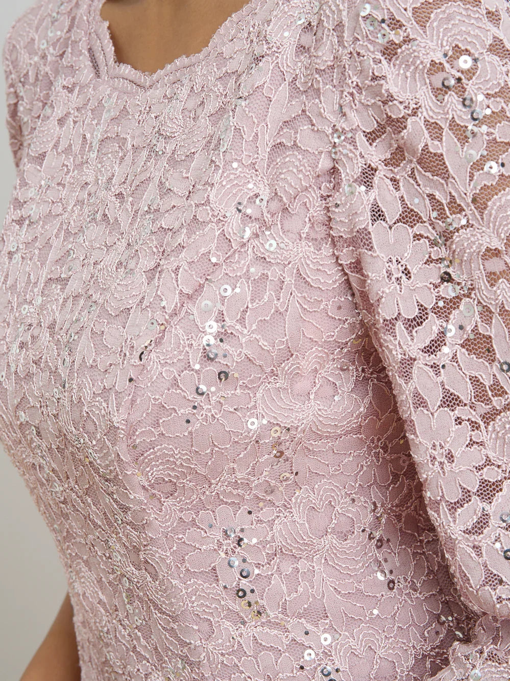 Dusty pink sequin lace bodice detail with floral patterns and sparkle