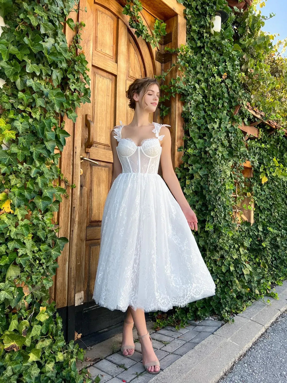 White lace tea-length formal dress with sweetheart neckline and bow-trim spaghetti straps