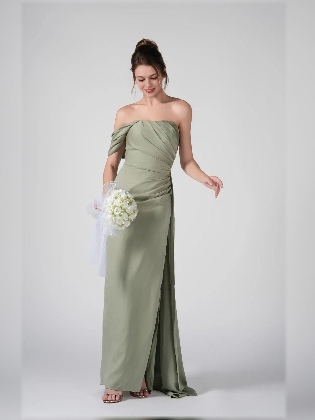 Dusty sage off-shoulder maxi dress with ruched bodice and side slit, holding bouquet