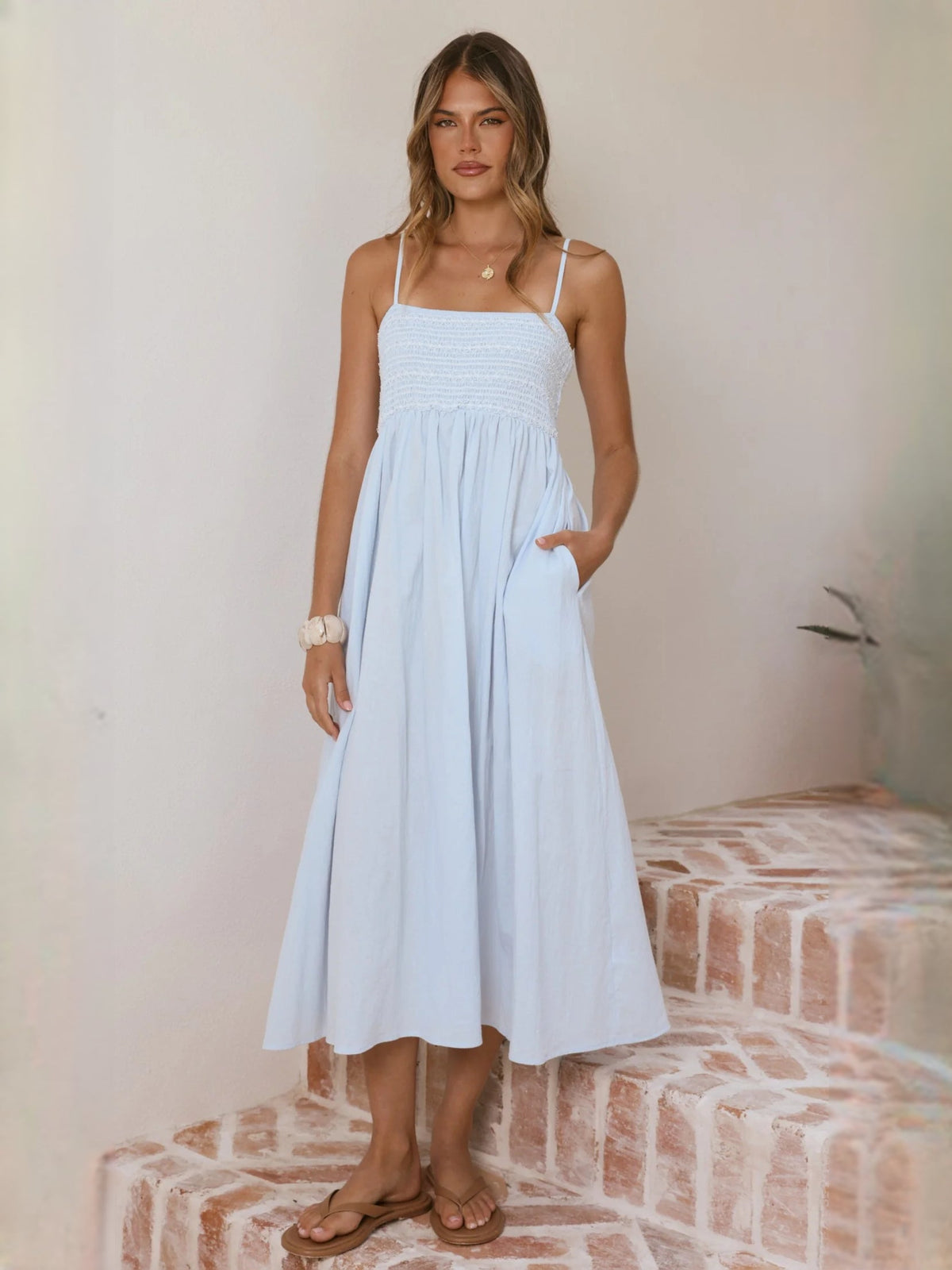 Light blue midi dress with spaghetti straps and gathered, tiered skirt