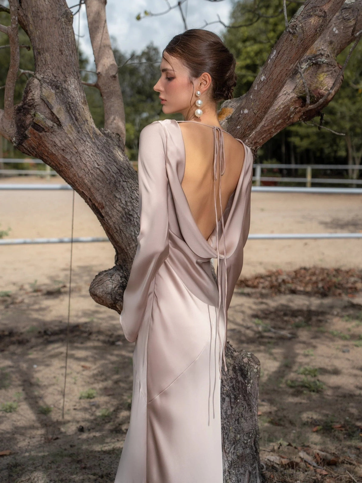 Ivory satin mermaid maxi prom dress with open back and thin tied crisscross straps