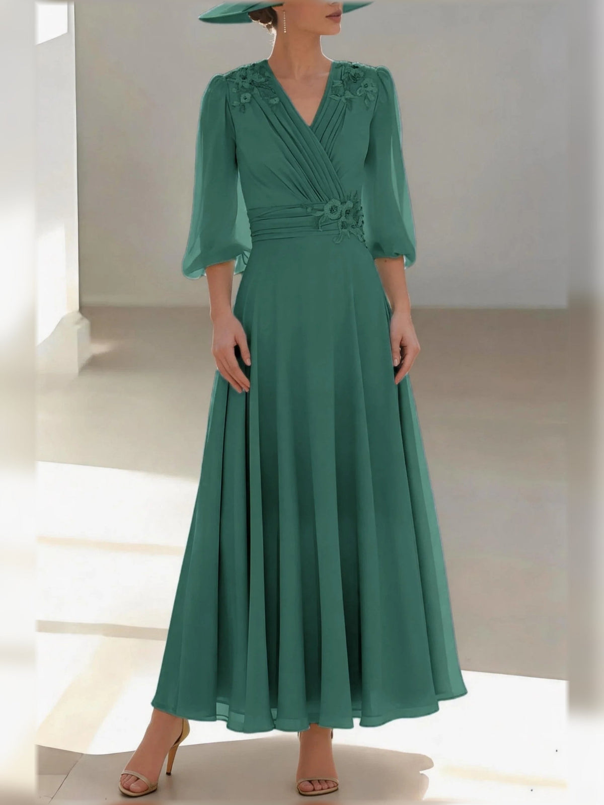 Emerald green chiffon V-neck A-line dress with floral applique, 3/4 sleeves, pleated skirt