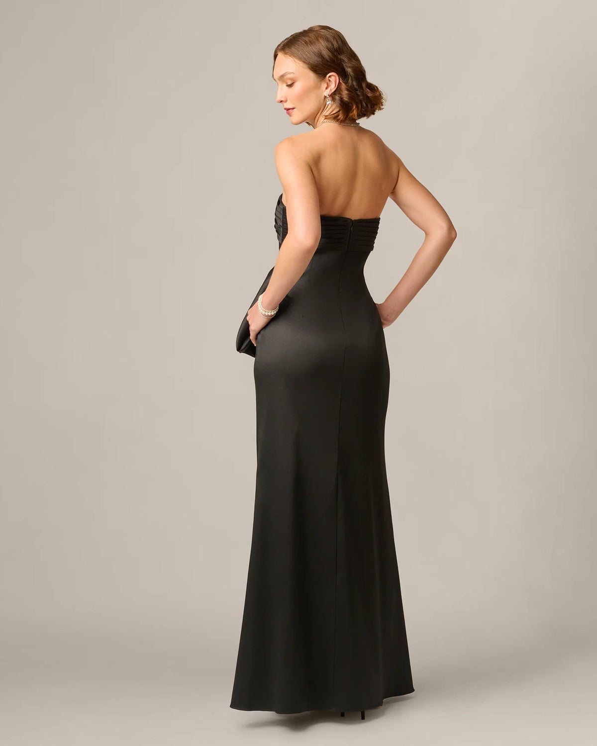 Black strapless maxi dress with low back and fitted waist, flowing A-line skirt