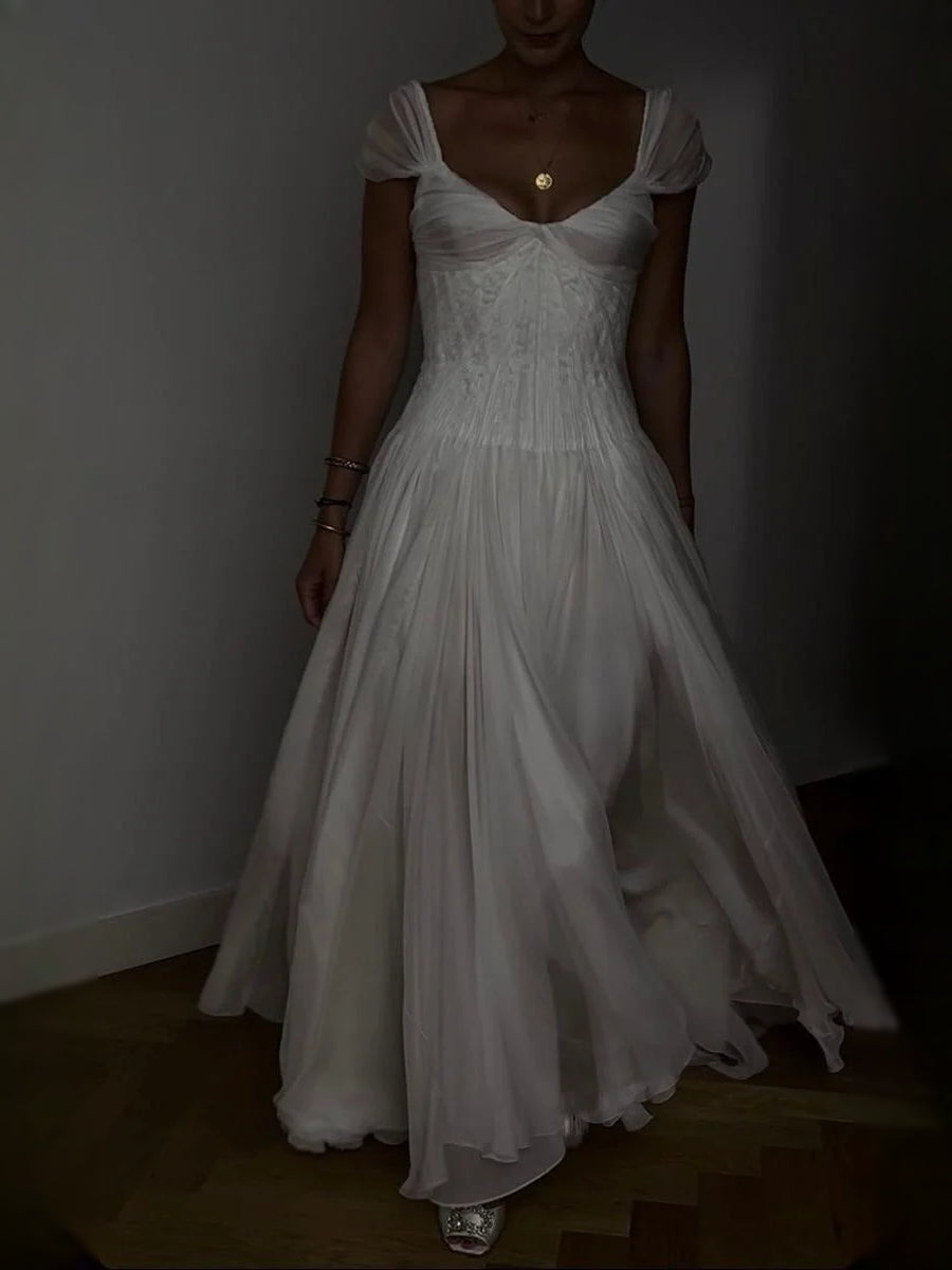 Ivory A-line wedding dress with sweetheart neckline and flowing pleated chiffon skirt