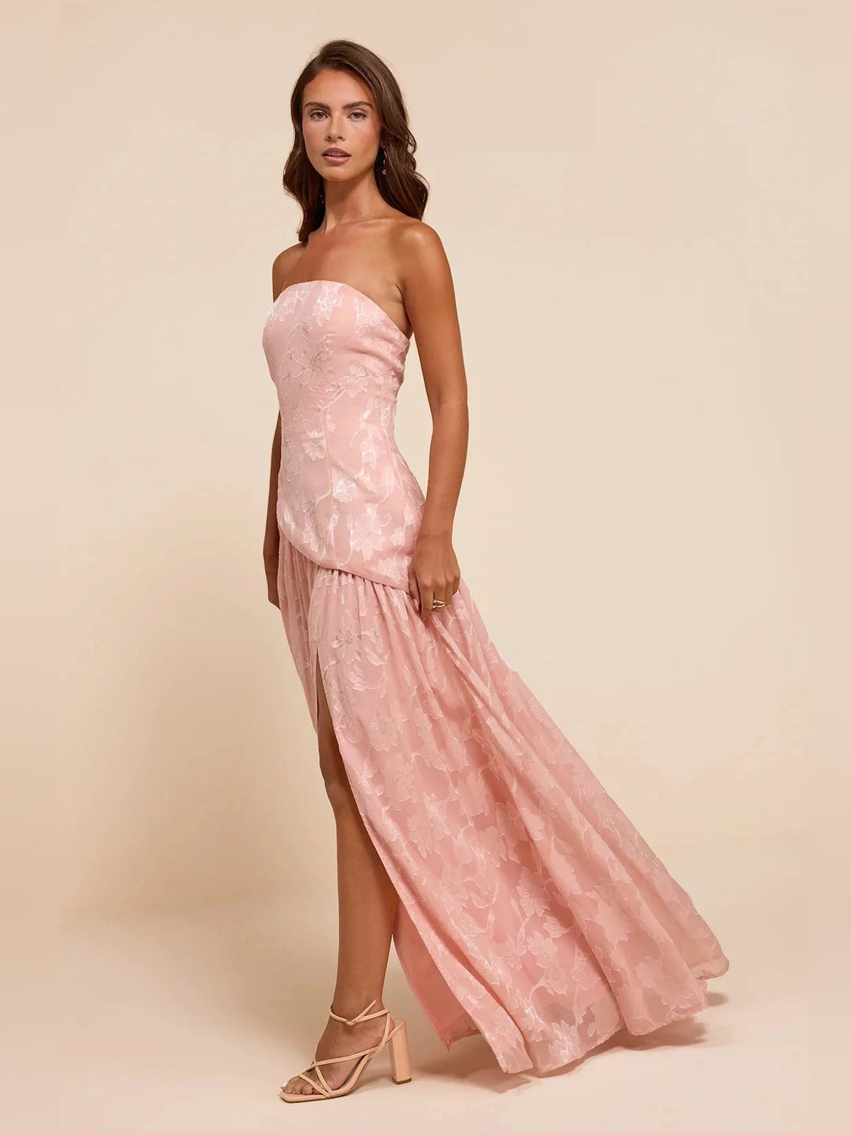 Dusty pink strapless maxi dress with floral lace, layered skirt, and side slit