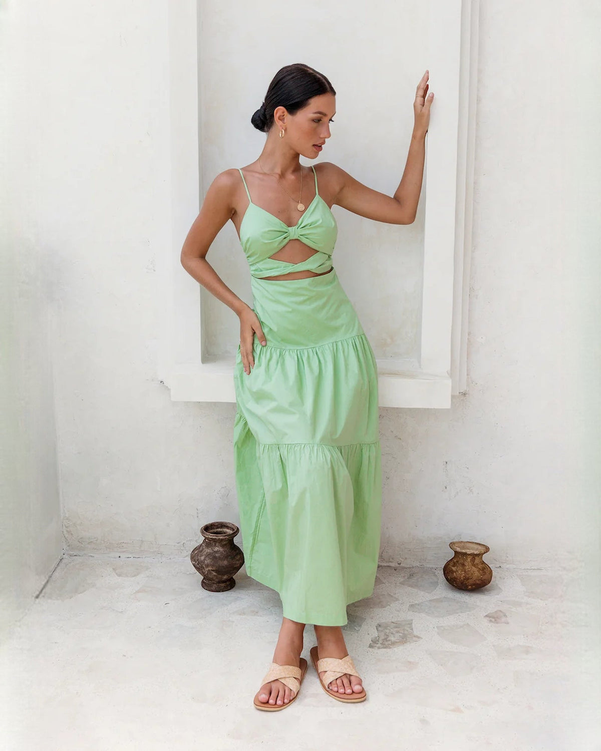 Light green sleeveless tiered maxi dress, back/side view with tiered ruffle hem