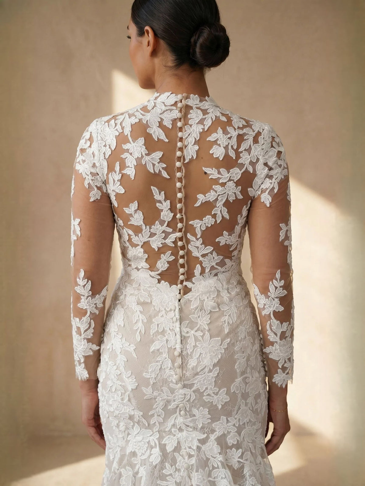 Ivory lace mermaid wedding dress with high-neck illusion back and sheer floral sleeves.