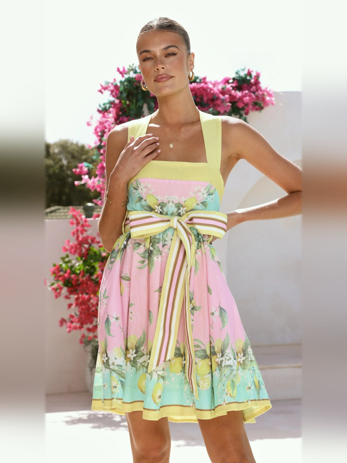Pastel lemon print mini dress with sleeveless square neckline and striped bow-tie waist
