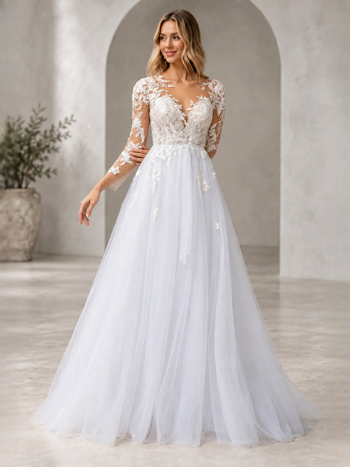 White V-neck wedding dress with fitted bodice, layered tulle skirt, and floral lace sleeves