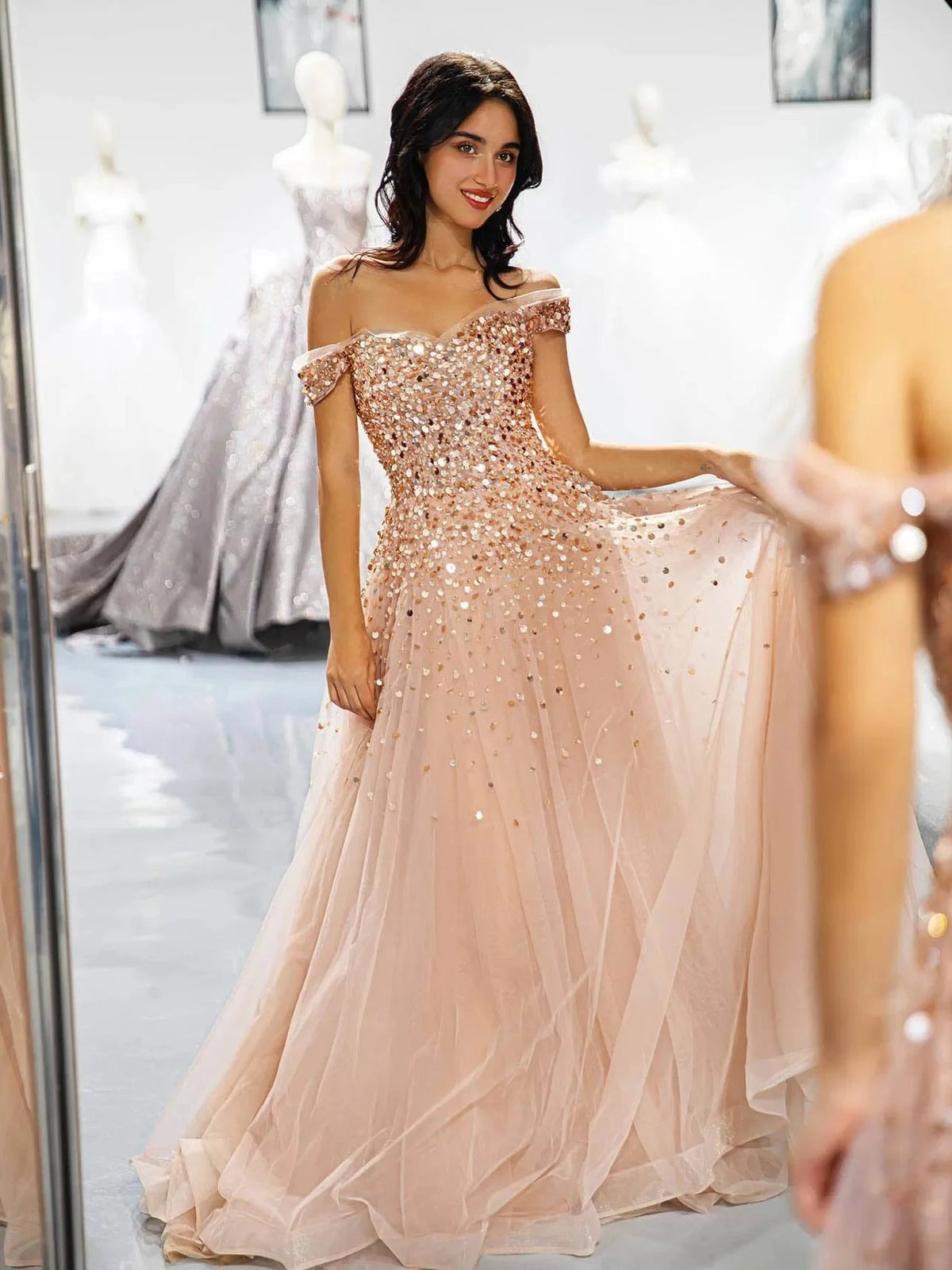 Champagne off-shoulder corset dress with glittering sequined bodice and tulle skirt