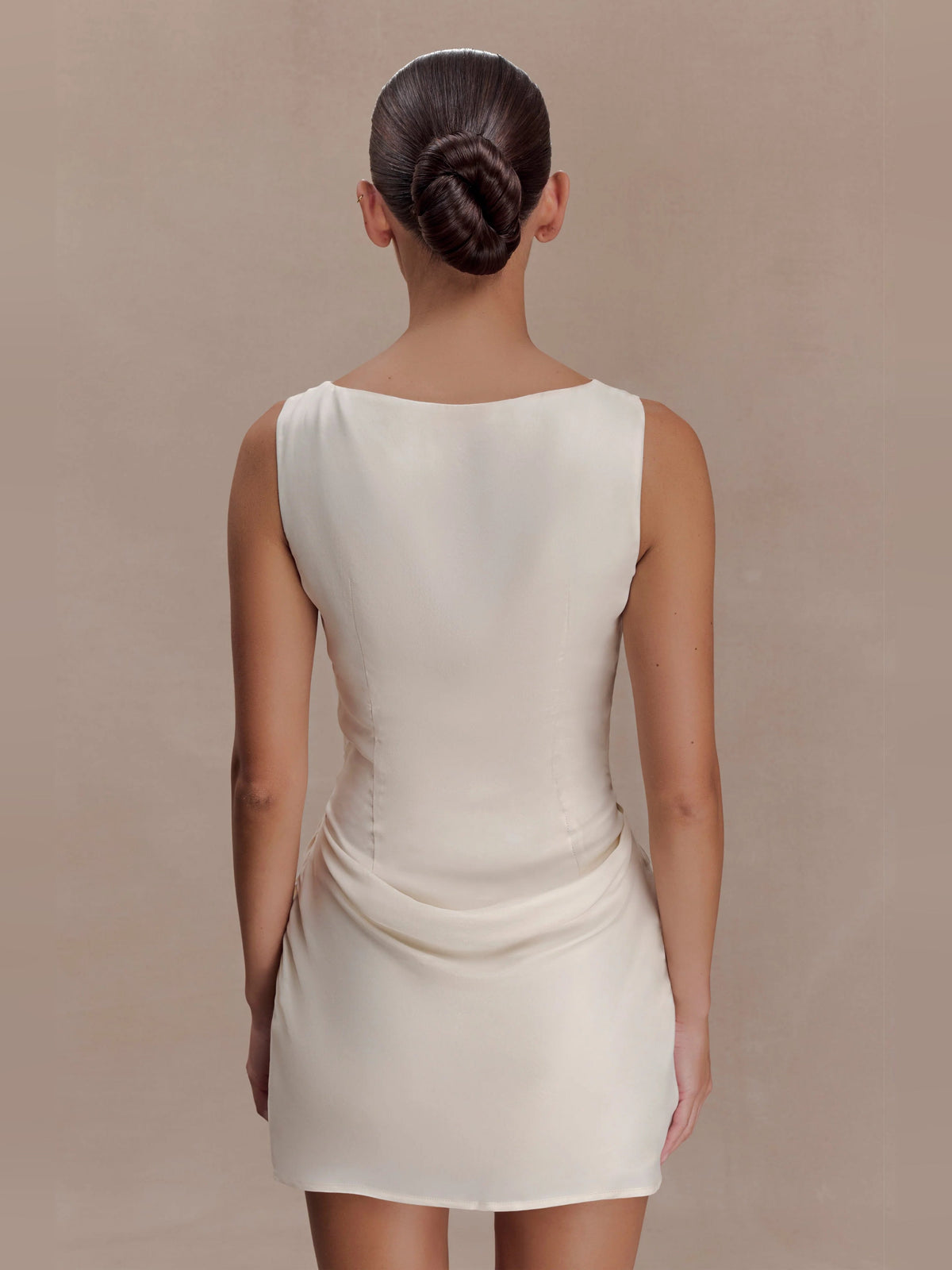 Ivory sleeveless mini dress, back view with draped waist detail