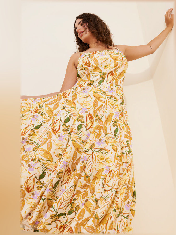 Orange floral midi dress with open back, spaghetti straps, and flowing tiered skirt