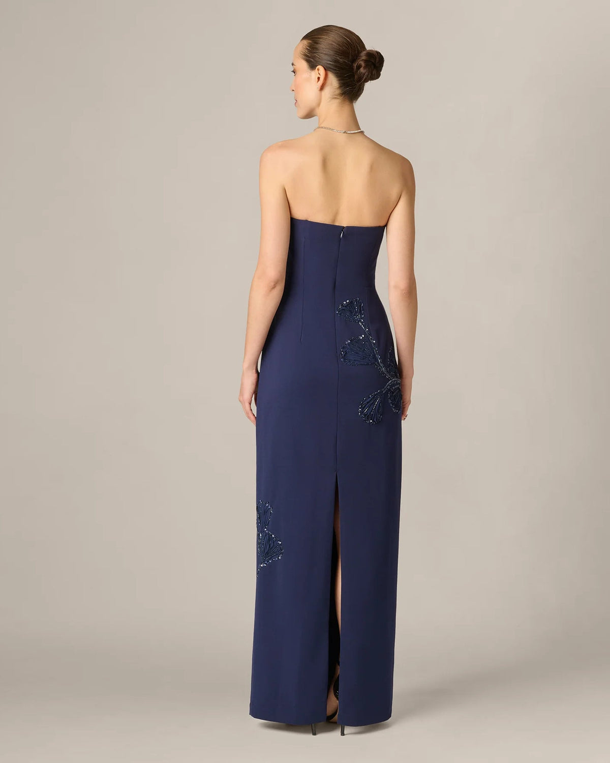 Dark navy strapless maxi dress with beaded floral accents, open back