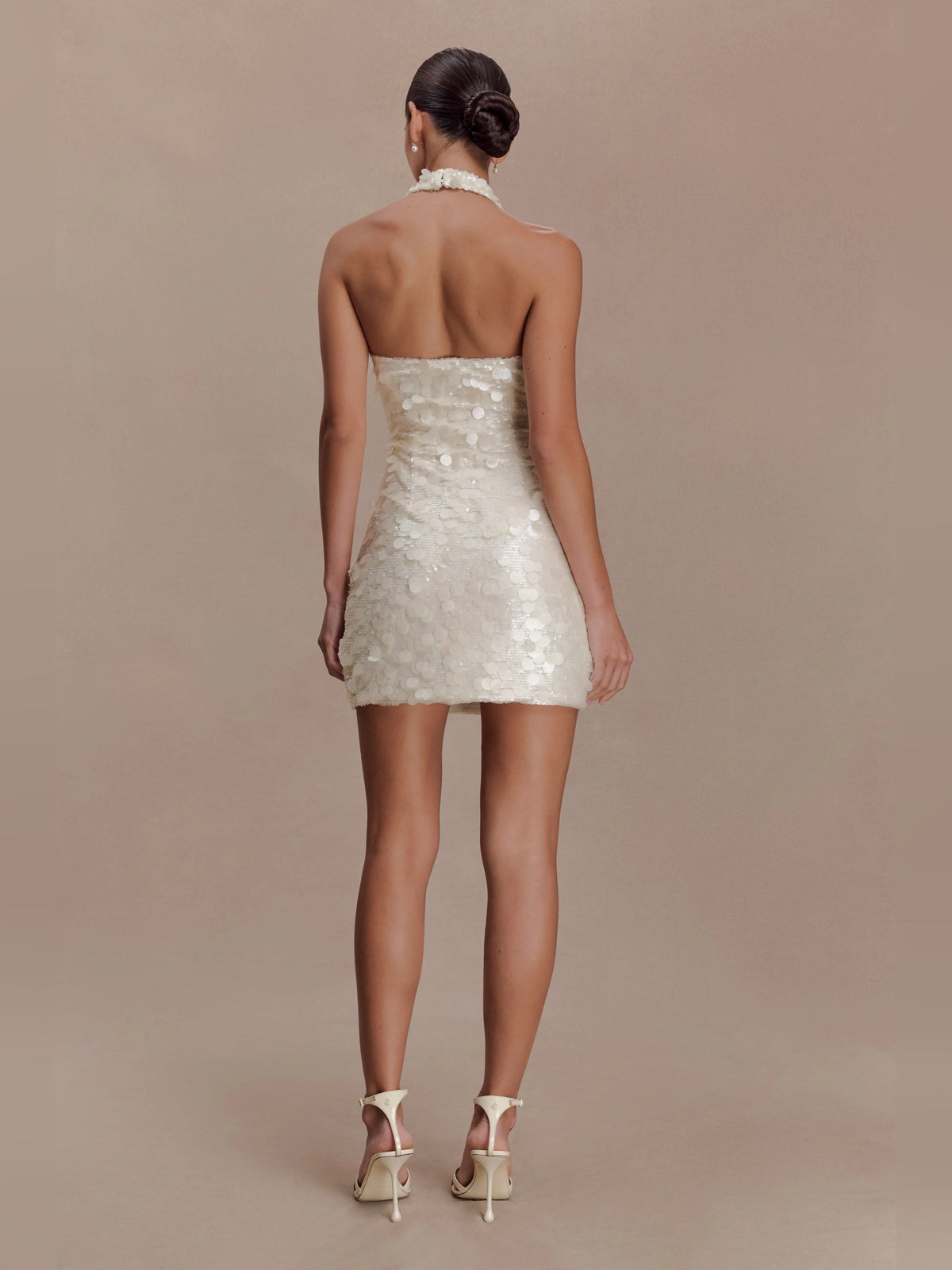 Ivory sequin mini dress with halter neckline and open-back design