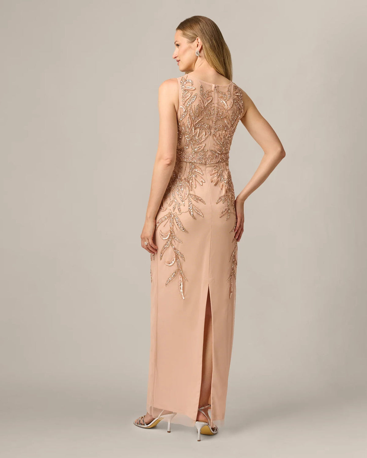 Rose gold sleeveless maxi sheath dress viewed from side with beaded neckline and bodice