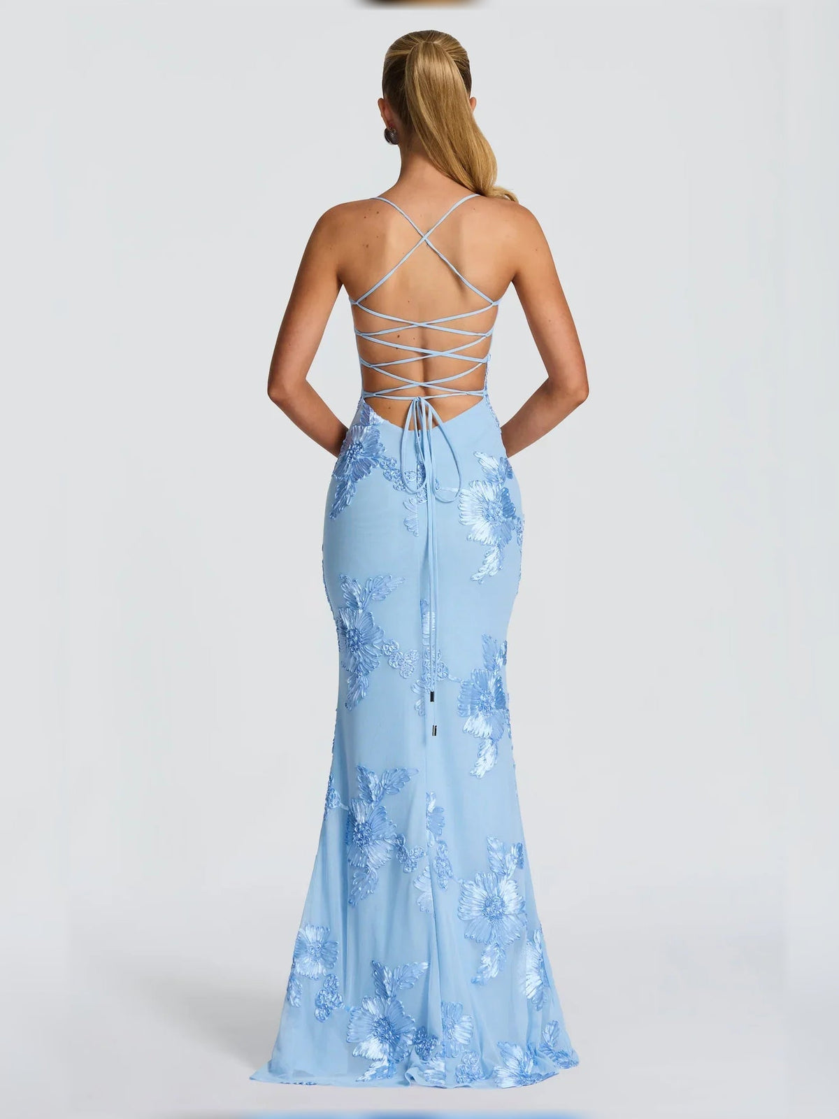 Back view of light blue embroidered formal dress with crisscross lace-up straps