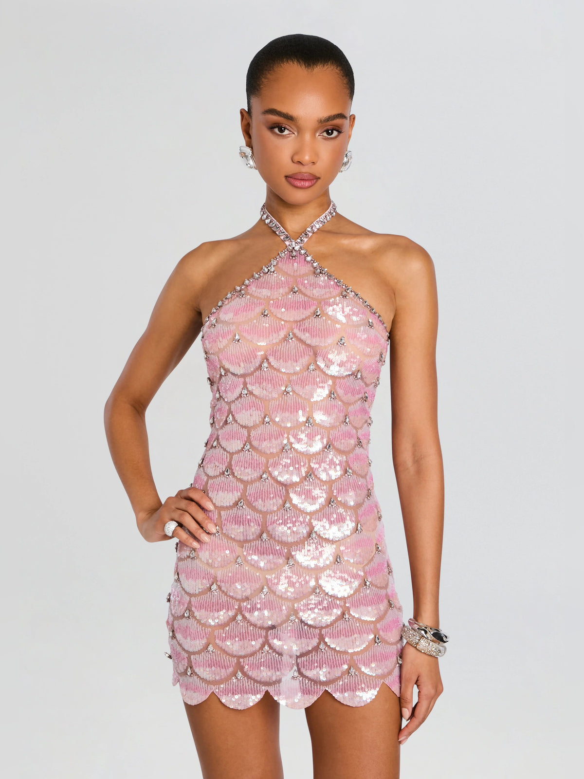 Pink sequin mini homecoming dress with halter neckline and sparkle bead detailing.