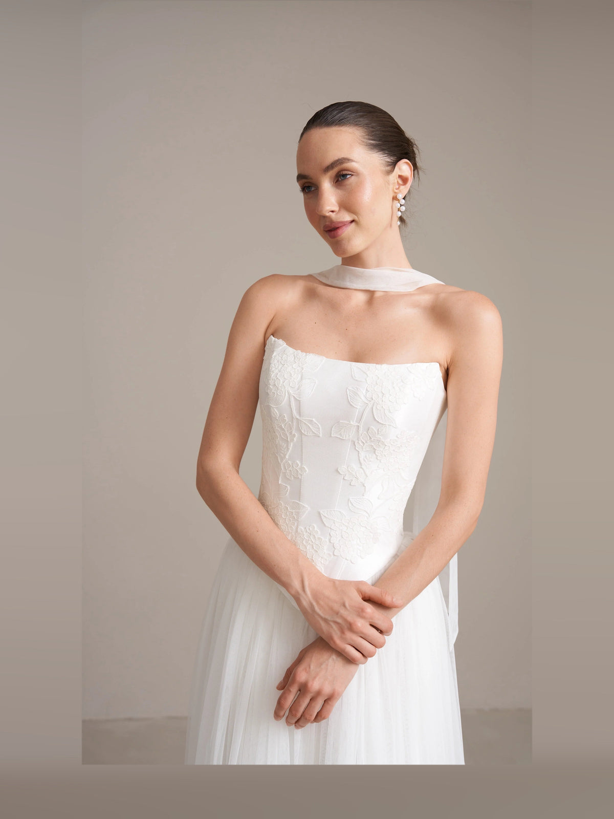 Ivory strapless corset wedding dress with textured bodice and flowing tulle skirt