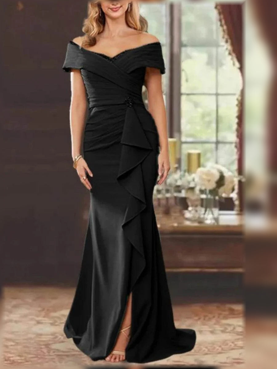 Black off-shoulder mermaid gown with ruched bodice, layered ruffles, and side slit.