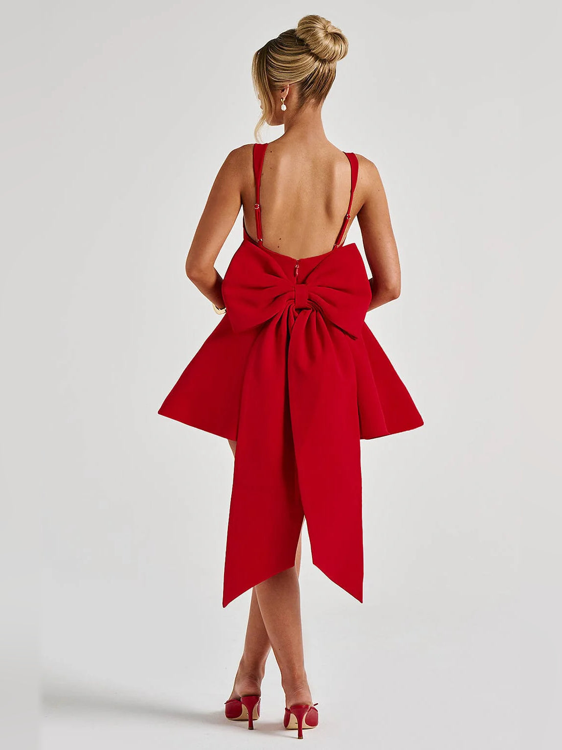 Red mini dress back view with bow detail and flared skirt, showing draped lower back