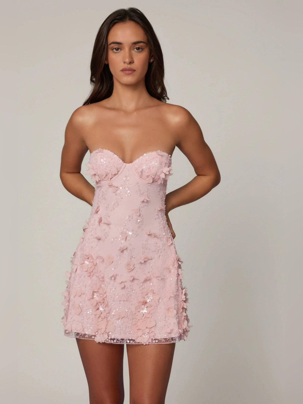 Pink A-line mini dress with strapless-style sweetheart bodice and 3D floral lace
